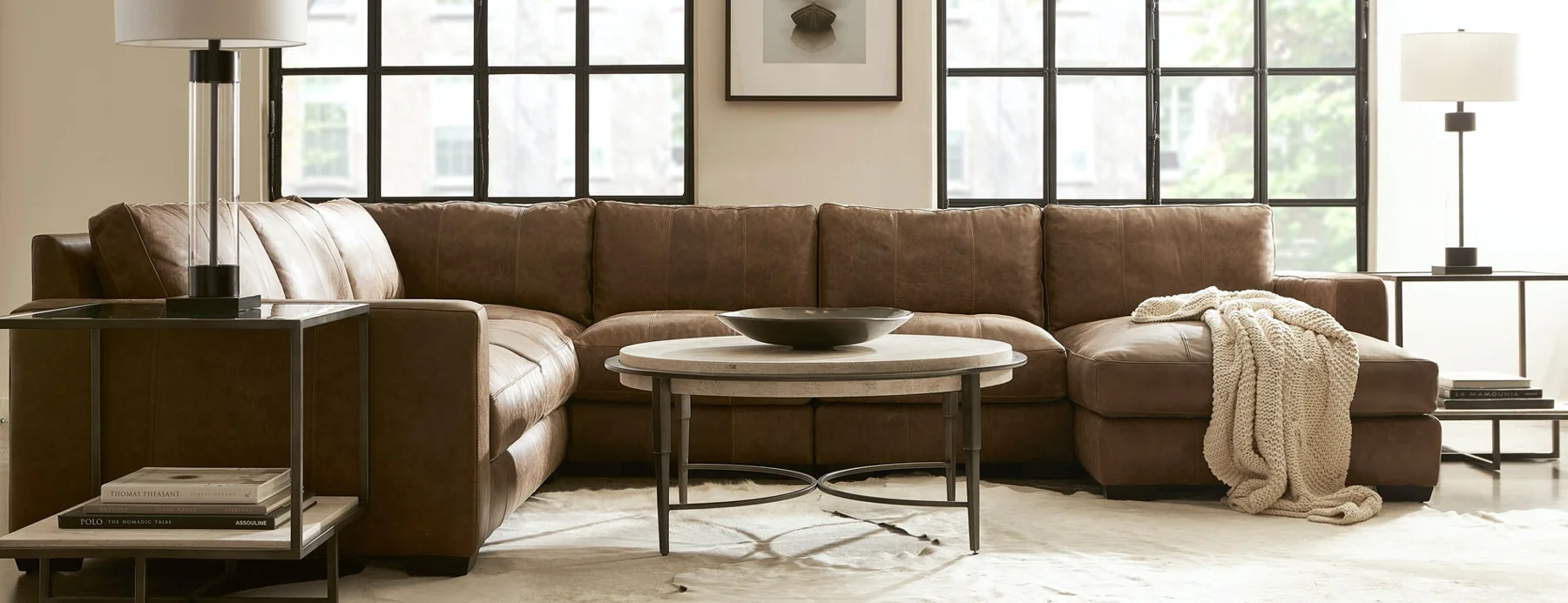 Comfortable sectional and occasional tables in a light-filled living room