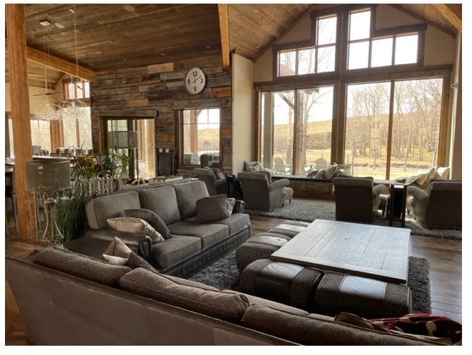 Client living space with timber beams and generous seating